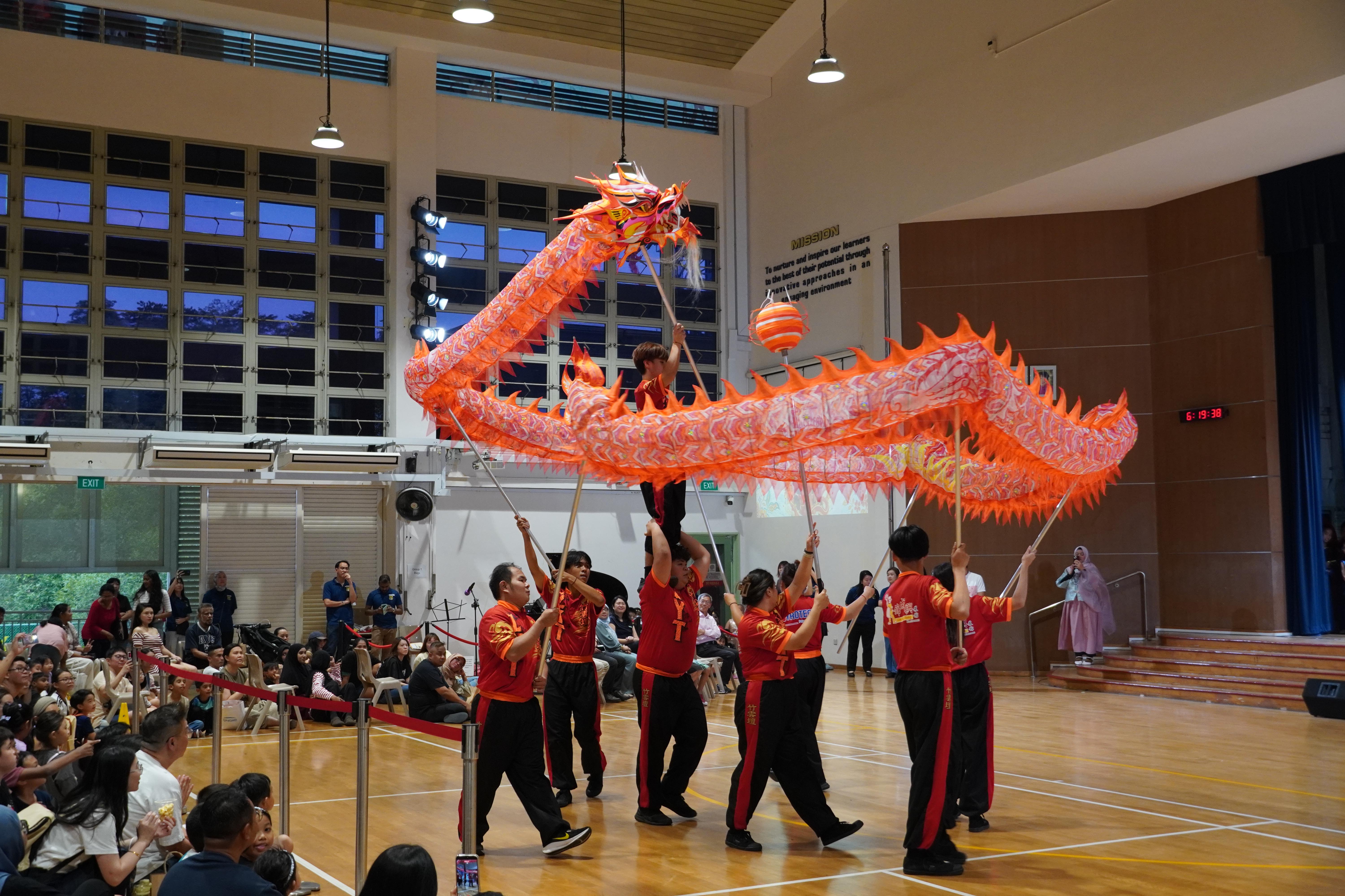 What a spectacular sight! The vibrant dragon twists and turns through the hall, bringing excitement to the crowd.